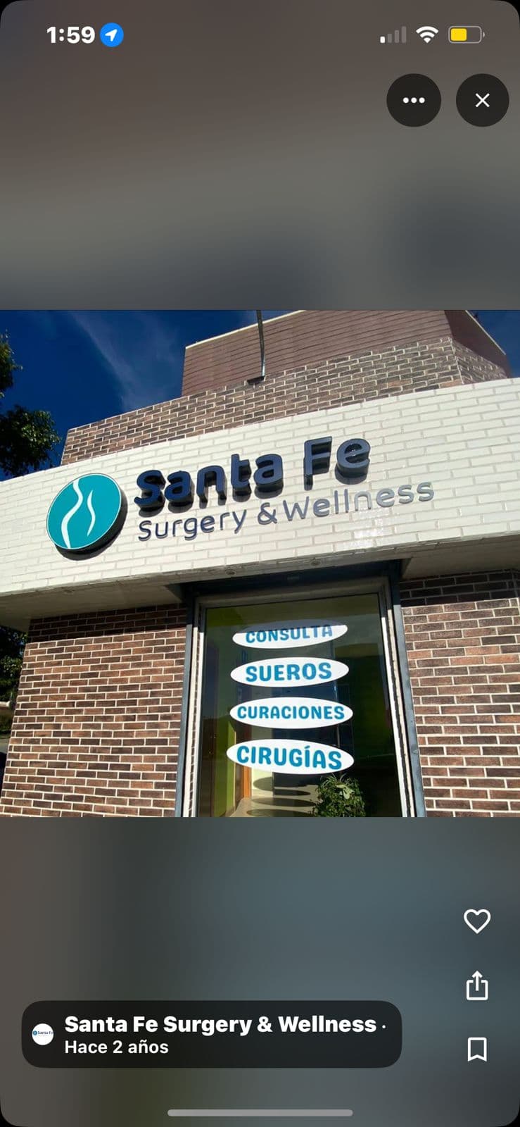 Santa Fe Surgery & Wellness clinic exterior with brick walls and Spanish medical service signs.